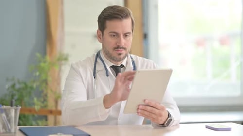 Male Doctor using Tablet in Clinic