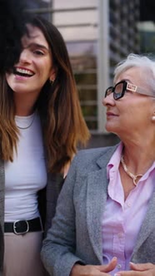 Three Women Chatting Outside a Modern Office Building