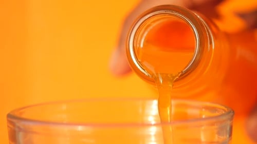 Pouring Refreshing Orange Juice into Glass