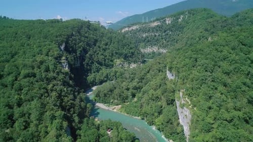Aerial of an Amazing Nature Scenery of Green Mountains Covered with Forest and River in the Valley