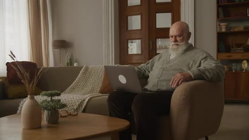 Senior Man Frustrated with Laptop in Stylish Home
