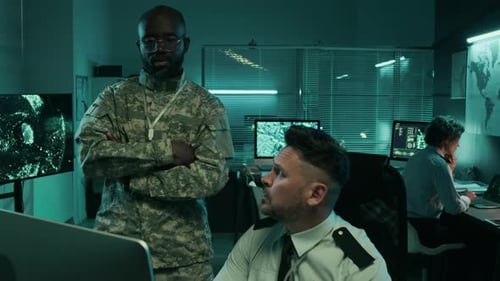 Men Working at Computers in a Dimly Lit Office