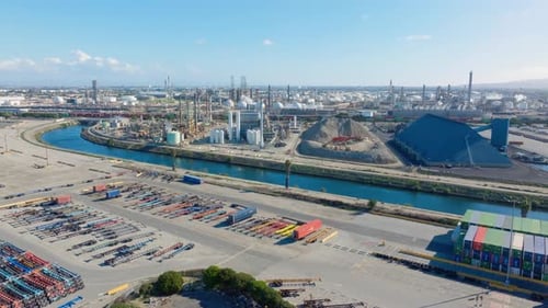 Aerial view of an oil refinery with distillation towers and storage tanks