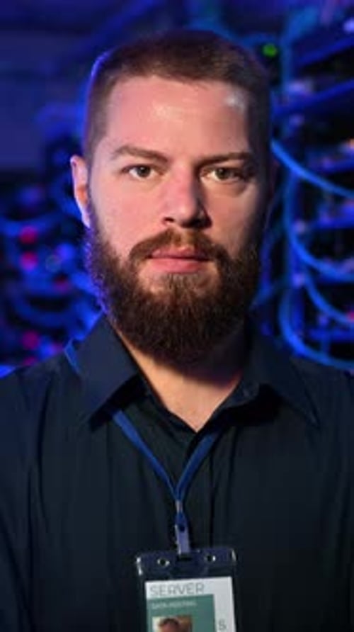 Man Standing in Front of Servers in Data Center