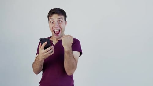Excited male man winner looking at mobile phone using app celebrating success, hand gesture yes!