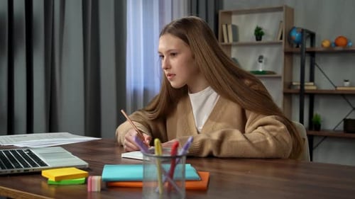 Diligent Teen Girl Studying at Her Desk