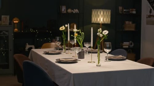 Festive Dining Table Decorated with Flowers and Candles at Home Celebration