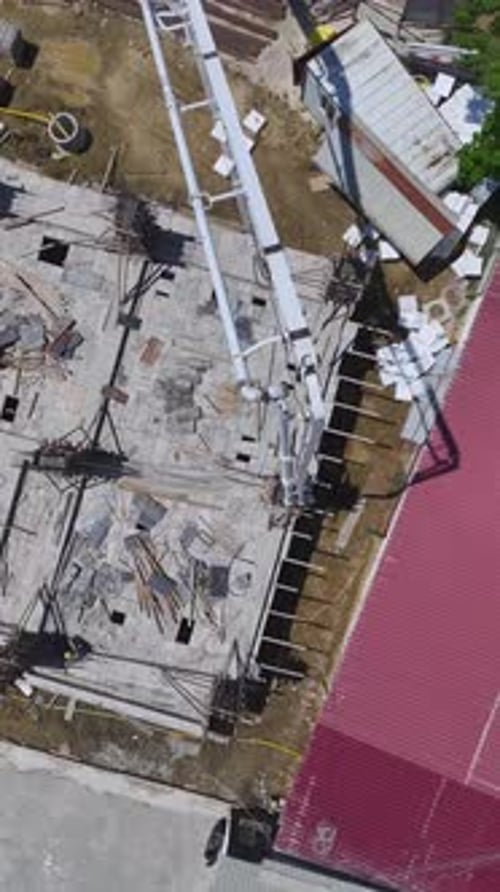 Vertical Video Developing Housing Area Features Workers Pouring Concrete and Finishing Exteriors for