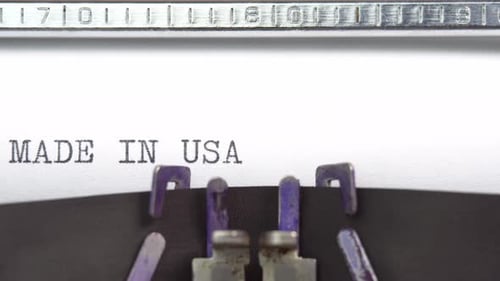 Made In Usa phrase closeup being typing and centered on a sheet of paper on old vintage typewriter