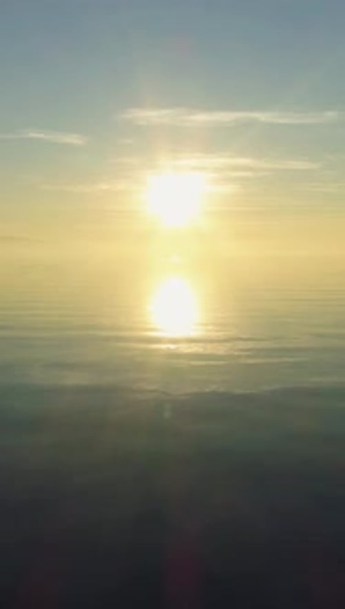 Vue aérienne verticale du lac Léman au coucher du soleil : reflet du soleil en Suisse