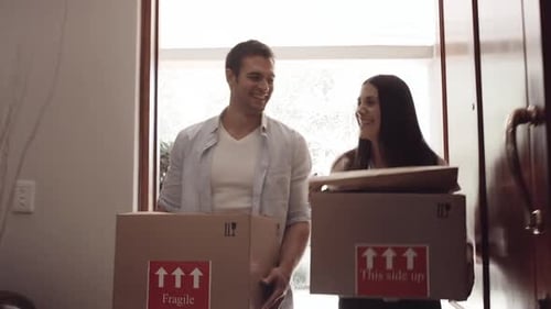Couple Carrying Boxes into New Home
