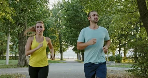 Happy Couple Jogging in Park