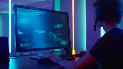 Young Man Plays Video Game in Neon Room