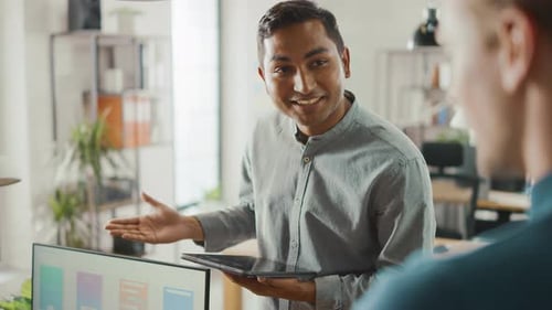 Two Men Discussing App Design in Modern Office