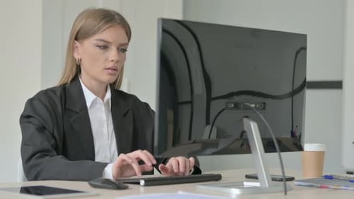 Woman Coughing While Working at Her Computer