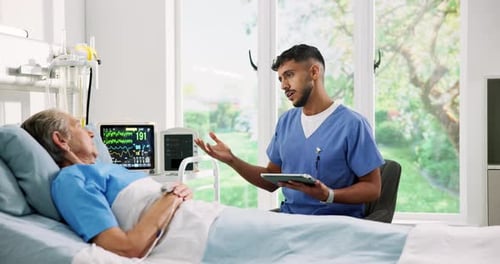 Attentive Doctor Visits Elderly Patient in Hospital Room