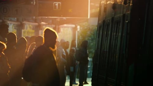 Crowd Gathers at Subway Station During Sunset Waiting for Train