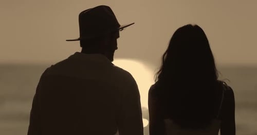 Romantic Couple Silhouetted on Beach at Sunset