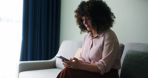 A Woman Typing on Mobile Phone Screen and Chatting in Living Room Woman's Hands Using Text Messages