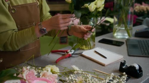 Unknown Woman Creating Flower Arrangement Using Floral Greenery and Roses