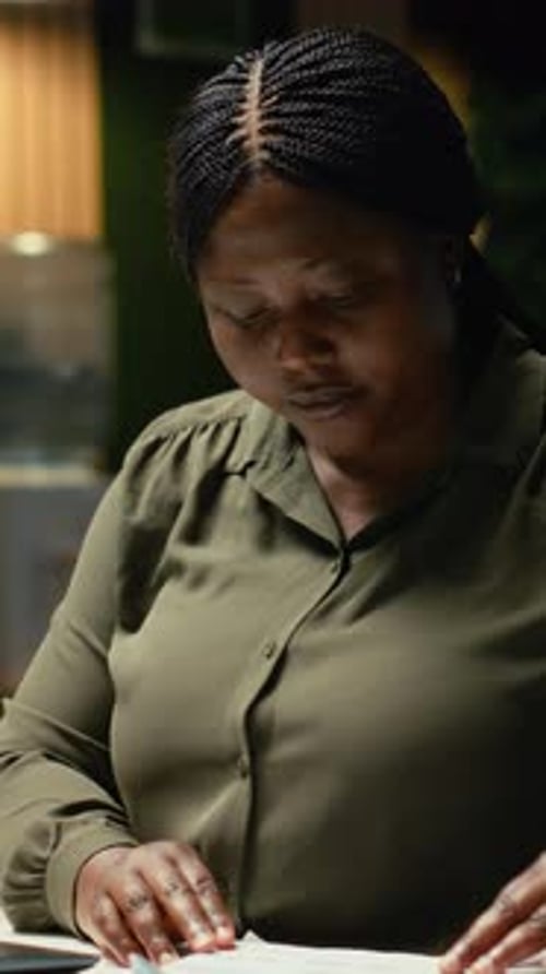 Vertical Video Female Employee Researching and Documenting Data Reports Numbers