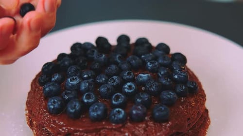 Decorating Chocolate Pancakes with Blueberries