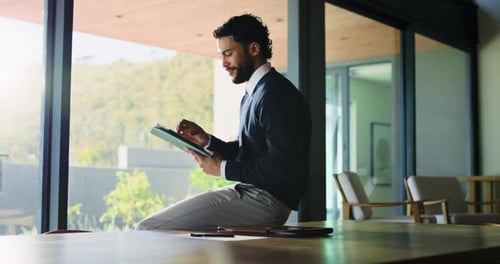 Business, man and reading with tablet in office for research, proofreading article and update draft