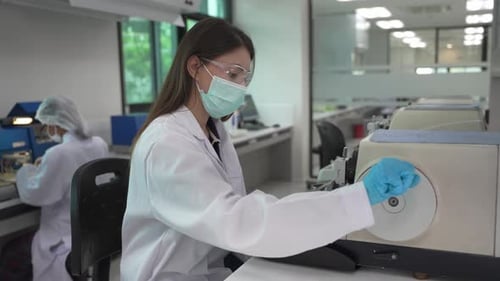Female Scientists Working with Lab Equipment in Lab
