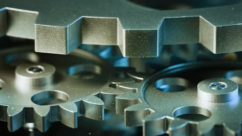 Silver Metal Gears Rotating in Close Up