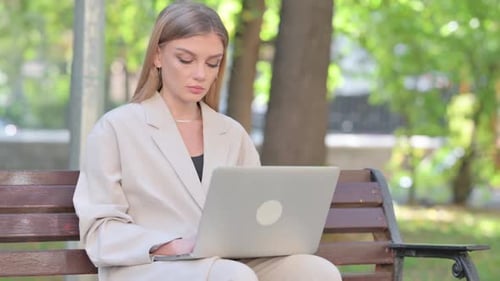 Woman Works on Laptop in Park