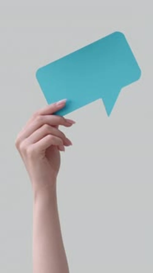 Hand Holding Blue Speech Bubble on White Background