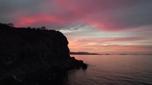Flying Next To Rocky Cliff In The Ocean During Sunset In Baja California, Mexico. - aerial shot