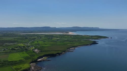 Tullan Strand,, County Donegal, Ireland, June 2023. Drone pulls backward and descends above the blue