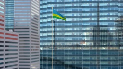 Flag of Rwanda Waving Over Modern Corporate Building