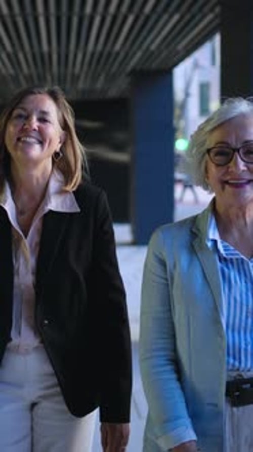 Three Only Business Women in Suits Walking Confident Looking Happy at Camera Outside Office Center