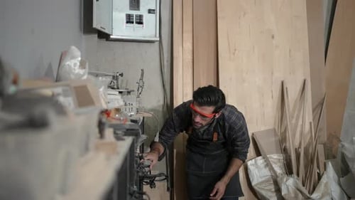 Carpenter is working at workshop.