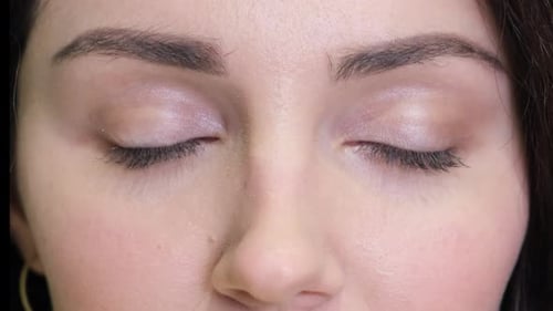 Woman Opens Eyes in Close Up Shot