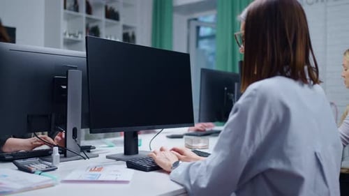 Young Adult Women In Modern Office Of Software Development Company Workers Typing Program Code