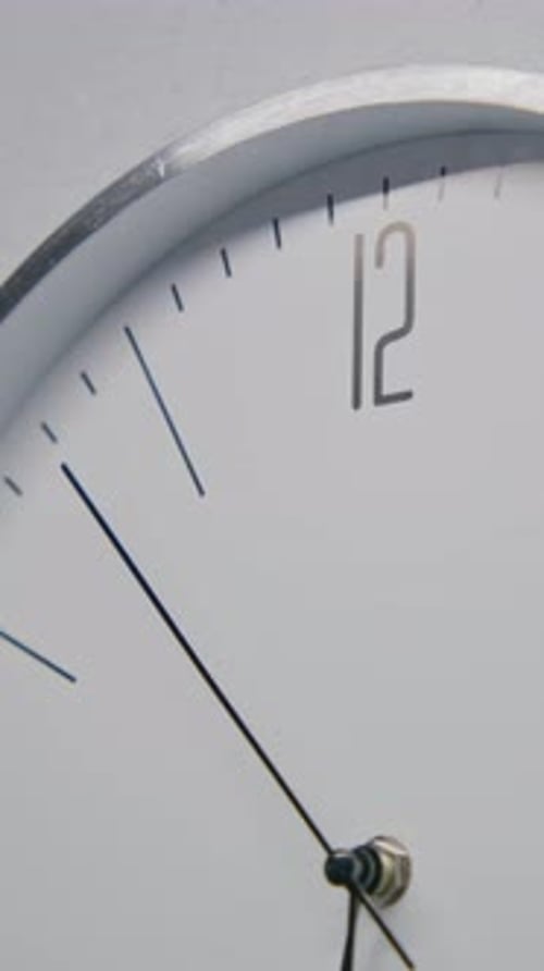 White Watch with Metal Frame Hangs on the Wall