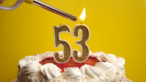 53. A candle in the form of the number 53 is lit, which is stuck into the holiday cake. Celebrating