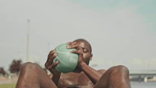 Muscular Black Man Doing Crunches Outdoors