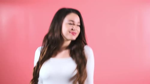 Young Woman Enjoys Dancing in Place with Excited Expression