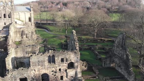 Aerial footage of the ruins of Kirkstall Abbey, a ruined Cistercian monastery in Kirkstall in the UK