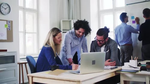 Young business team collaborating on a laptop in a modern office space
