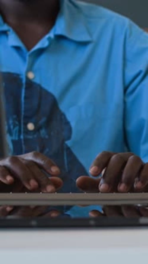 Young Black Male Programmer Typing On Computer