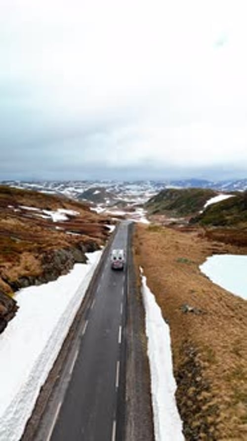 Campervan or Motorhome Camper Van at the Lyse Road Covered with Snow to Krejag Norway
