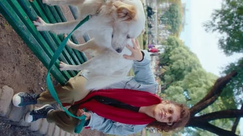 Woman Petting Cute Dog on Park Bench