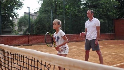 Girl Tennis Lesson on Outdoor Clay Court