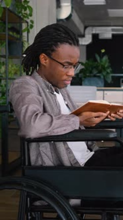 African American Student in Wheelchair Studying Book