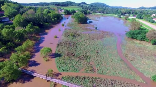 A River nearly over taking a old footbridge in a small town in Wisconsin during a 100 year flood